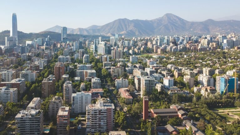 Daytime aerial view of Santiago, Chile, with city buildings and green spaces